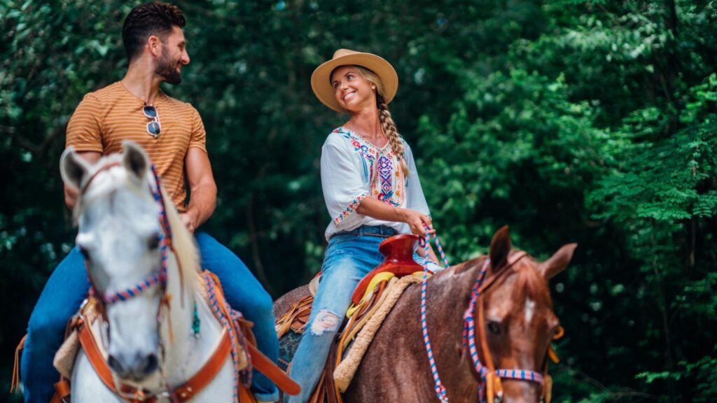 couples riding horses on vacation 